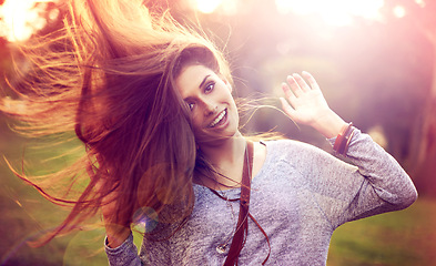 Image showing Portrait, dance and hair for happy woman person, nature and freedom in outside park. Smile, confidence and dancer in summer for sunset with lens flare, joy and fun from celebration or achievement