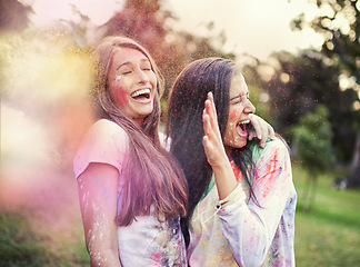 Image showing Happy, powder paint and girl friends laugh outdoor with Holi festival and colorful event with smile. Celebration, love and excited in nature with young people and crazy color dust for party together