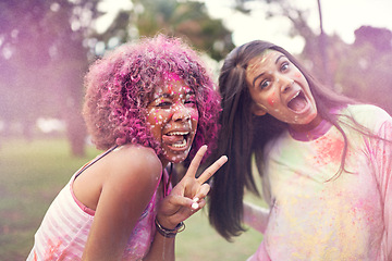 Image showing Color, festival and friends with peace sign for fun, splash and outdoor social gathering for spring, nature and smile. Powder, paint and celebration in park with excited women at happy event together