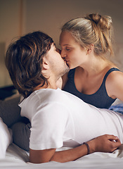 Image showing Love, kiss and couple on a bed with care, trust and support, security and bonding in their home together. Morning, romance and people embrace in a bedroom with intimacy, moment or fun in their house