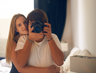 Image showing Camera, photography and couple on a bed with love, care and bonding in their home together. Lens, picture and portrait of people hug in a bedroom with support, security vacation memory in their house