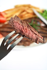 Image showing Grilled steak on fork