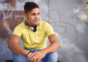 Image showing Smile, thinking and young man at skatepark for skating practice or training for competition. Happy, gen z and face of cool male person sitting on ramp with positive, good and confident attitude.