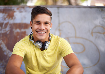 Image showing Smile, portrait and young man at skatepark for skating practice or training for competition. Happy, gen z and face of cool male person sitting on ramp with positive, good and confident attitude.