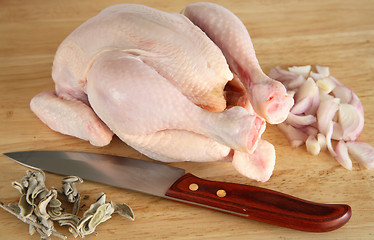 Image showing Chicken with sage, onion and knife