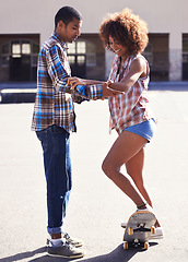 Image showing Happy, learning and man with woman on skateboard in city on romantic and fun date together. Smile, couple and African male skater teaching skating to young girlfriend in urban town with love.