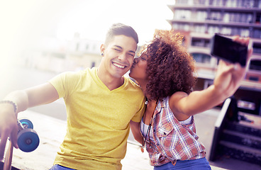 Image showing Interracial couple, smile and selfie with smartphone in city for date, vacation and travel in outdoor. Cellphone, happy man and woman together for skateboarding in social media, memory or romance