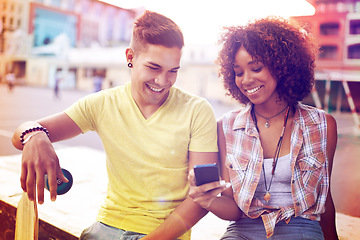 Image showing Interracial couple, skatepark and smartphone for online post, social media or communication in city. Skateboard, happy man and woman with mobile phone for memories, weekend trip and networking