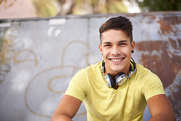 Image showing Smile, gen z and portrait of man at skatepark for skating practice or training for competition. Happy, fun and face of cool male person sitting on ramp with positive, good and confident attitude.