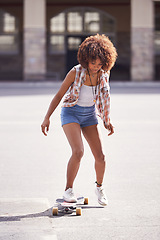 Image showing Woman, skateboard and ride at urban skatepark, sports and energy with skill, technique and recreation activity outdoor. Skateboarder, practice and training with workout for balance and exercise