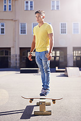 Image showing Man, skateboard and balance at urban skatepark, sports and skill with beam or ramp for recreation activity outdoor. Skateboarder, technique and trick, training and workout for riding and exercise