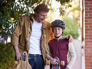 Image showing Father, son and skateboard outdoor for sports and fun together, bonding for love and relationship. Happy people, skating and activity in neighborhood for family time, helmet for safety and hobby