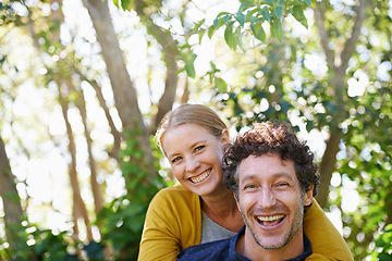 Image showing Happy, couple and piggyback outdoor in portrait for love and bonding, trust and support in commitment for marriage. Partner, loyalty and fun with people in nature for fresh air on date for romance