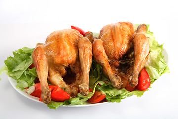 Image showing Two roast chickens on a bed of salad