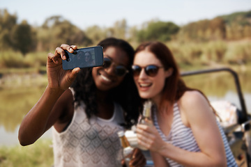 Image showing Women, selfie and vacation for road trip by river, memory and travel adventure for social media in nature. Ladies, cellphone and profile picture by van on holiday, care and bonding together on safari