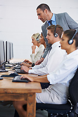 Image showing Help desk, manager and phone call with team typing on computer, consultation and customer support. Headset, telemarketing and client service agent at callcenter with training in coworking space