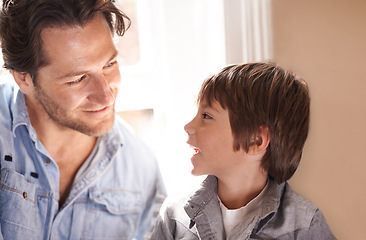 Image showing Dad, boy and smile conversation in home, happy son and man bonding for child development and paternal relationship. Kid, family vacation house and male person listening or discussion on Fathers day