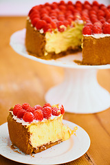 Image showing Slice, dessert and cheesecake for bakery, raspberries and sweet snack for eating. Fruit, plate and cake stand for display on table in pastry restaurant, creamy or luxury baked confection with berries