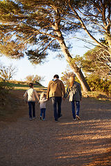 Image showing Family, nature and walk for exercise, fitness and bonding for parents and children. Sunset, autumn and forest for hike on holiday in English countryside, mother and father for outdoor activity