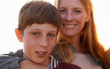 Image showing Portrait, son and mother person with summer sunset, family and smile for happy parent. Child, boy or teenager with affection or hug from loving mom people, bonding and love with lens flare in nature