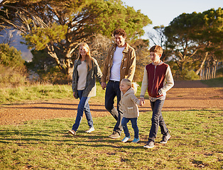 Image showing Happy, family and children on nature walk, summer fun for health in morning. Exercise in forest with kids holding hands, smile in field on vacation or holiday with people together in calm outdoors