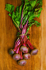 Image showing Beetroot, closeup and counter for nutrition, wellness or organic diet on wood countertop. Vegetable, health or produce for eating, gourmet and meal or cuisine with vitamins or fibre for weight loss