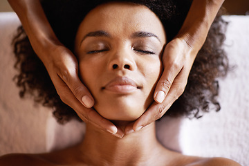 Image showing Woman, spa and massage on face with hands and care for facial, wellness and beauty treatment on bed. Above, towel and calm african female person with skincare and relax at a hotel with skin glow