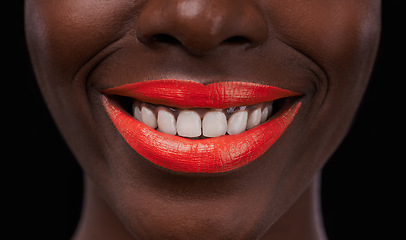 Image showing Black woman, lipstick and smile for beauty, cosmetics and bright makeup color on dark background. Bold, vibrant and orange lip balm with happy model, cosmetology and teeth for glamour in studio