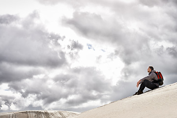 Image showing Travel, backpack or thinking man in desert for adventure, journey or resort, location or exploration. Freedom, holiday or backpacker in Egypt for sand dunes reflection, wellness or hiking in nature