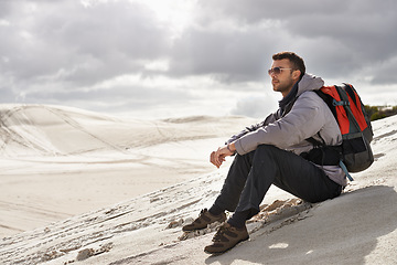 Image showing Thinking, backpack or man in desert for travel adventure, journey or resort, location or exploration. Peace, holiday or backpacker in Egypt for sand dunes reflection, wellness or hiking in nature