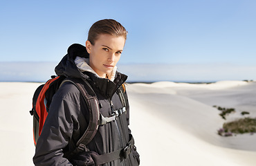 Image showing Portrait, sand dunes or woman in nature to hike for adventure, desert landscape and travel for holiday. Mockup, hiker or nomad explorer in Sahara terrain, outdoor and dry climate for view or scenery