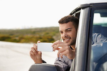 Image showing Road trip, man and cellphone for photography in car, game route and sightseeing for driving for journey. Person, traveller and exploration on holiday in nature, street and leisure in vehicle in oman