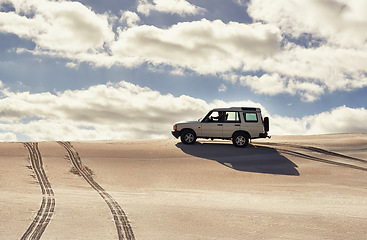 Image showing Car, desert and driving with travel and transport outdoor, off road vehicle for sand dunes and journey on vacation. Van, 4x4 and SUV with adventure, exploration and destination for tourism in Dubai