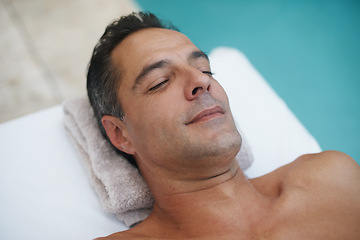 Image showing Spa, man and relax for massage on table at poolside, calm and care for body in holiday. Vacation, outdoor and male person on getaway for weekend and hotel or lodge with treatment for skincare