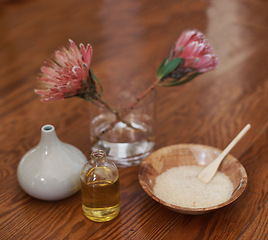 Image showing Hotel, aromatherapy or spa with flowers, oil for zen, calm or peace to relax for health or natural healing. Protea plant, wellness or salt for wellbeing, holistic massage or hospitality background