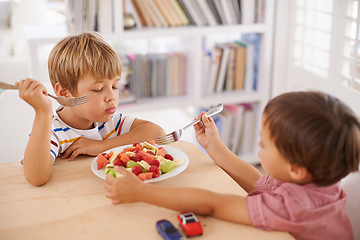 Image showing Children, boys and eating fruit salad for lunch in dining room for nutrition, healthy meal and wellness in home. Siblings, kids and breakfast bowl with watermelon, grapes and berries for sharing