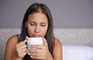 Image showing Woman, eyes closed or coffee in bed to wake up in peace on morning routine as mental health. Tired, sleepy or female person for tea, warm or comfort as soothing, self care or stress relief in bedroom