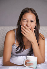 Image showing Woman, yawn or coffee in bed for energy to wake up in peace, morning routine for mental health. Tired, sleepy or female person in cozy, comfort or warm for tea as soothing, self care or stress relief