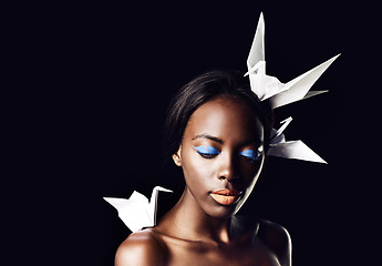 Image showing Black woman, makeup and fine art with beauty, dove or origami birds on a dark studio background. Closeup or face of African female person or model with creative cosmetics or eyeshadow on mockup space