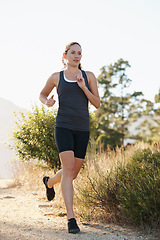 Image showing Athlete, woman and running on trail with fitness for sport, training or exercise for competition on mountain. Marathon, person or runner with wellness, challenge or cardio for healthy body in Denmark