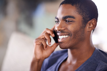 Image showing African man, phone call and home on sofa with smile for conversation, contact and listening in lounge. Person, smartphone and happy for mobile connection, talking and chat on couch in house.