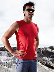 Image showing Athletic man, confident and beach for fitness, health and wellness in activewear and sunglasses. Male person, jog and seaside for sport, train and triathlon in exercise for cardio outdoor routine