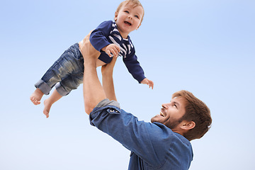 Image showing Happy, baby and smile father lift child with blue sky, family fun for excited kid with love in development and growth. Affection, man play airplane with kid outdoor for quality time game on vacation