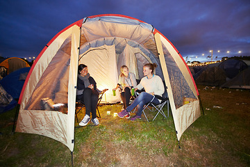 Image showing Happy woman, friends and night in tent at festival for party, event or carnival on outdoor campsite. Female person, people or group in relax or camping in the late evening with drinks and candlelight