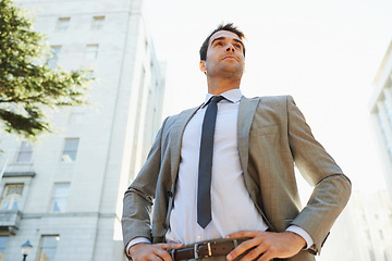 Image showing Professional man, city and buildings with pose for thinking, ideas or vision in Los Angeles. Business person, entrepreneur and confidence outdoors for opportunity, mindset and ambition from low angle