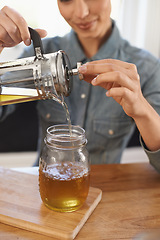 Image showing Closeup, woman and hands with brewing tea to start morning, cafe and table before work. Plunger, pouring and healthy beverage in jug for customer, breakfast and drink to enjoy beautiful day.