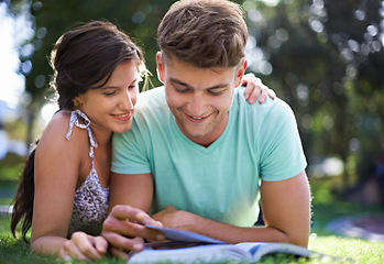 Image showing Happy, grass and couple with books for reading, learning and studying together outdoors at college. University, education and man and woman with textbook in park for bonding, relax and rest on campus