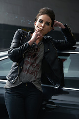 Image showing Woman, waiting and smoking cigarette on car in parking lot for pick up or transportation. Female person, smoker or driver in fashion with leather jacket and inhaling tobacco by stationary vehicle