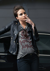 Image showing Woman, car and cigarette with smoking, night and trendy grunge style for pensive, insight and decision. Fashion, model and mystery with punk, leather jacket and tobacco on street, thinking and choice