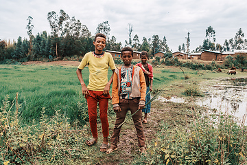 Image showing Ethiopian teenagers covered with a blanket to keep out the cold. Demebecha, Ethiopia